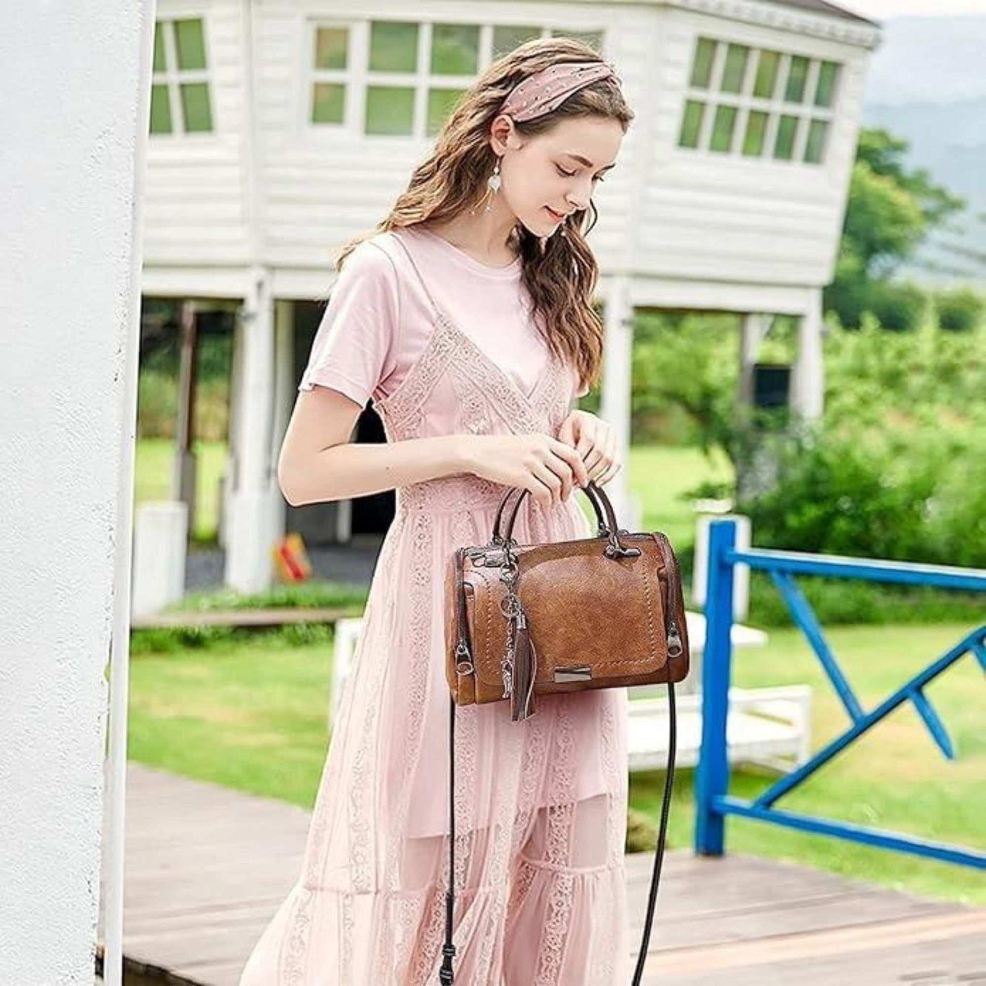 women with stylish handbag in nature